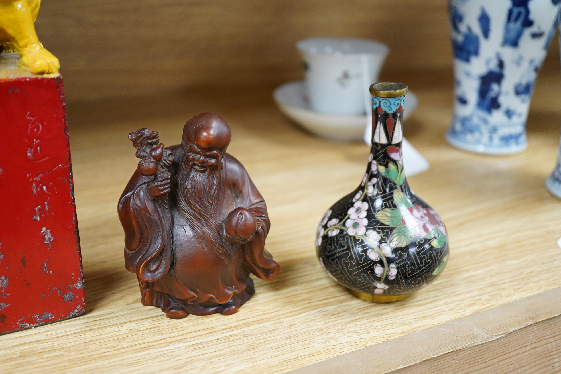 A pair of Chinese cloisonné enamel vases, a soapstone seal, an 18th century Japanese lacquer box and a wood figure of Shou Lao, tallest 19cm